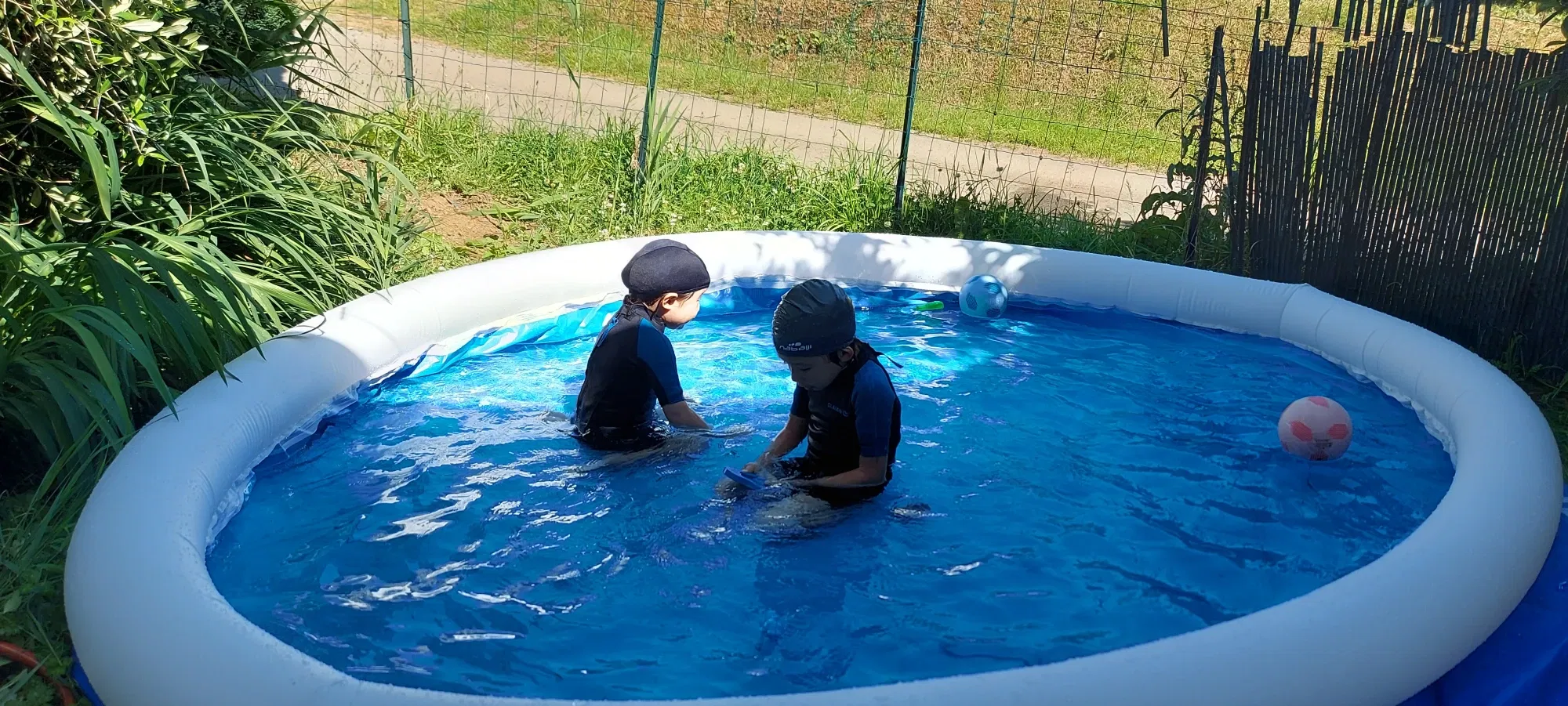 It's summertime! Inflatable swimming pool at the backyard